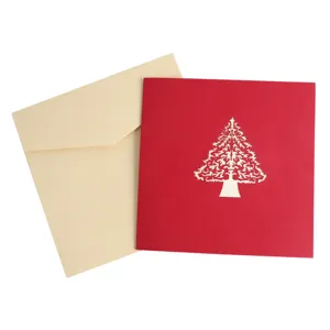 Handmade 3D pop-up Christmas tree greeting card with elegant envelope for holiday wishes.
