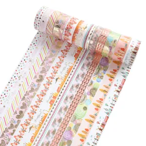 Detailed view of decorative washi tape rolls with gold foil patterns and pastel designs.