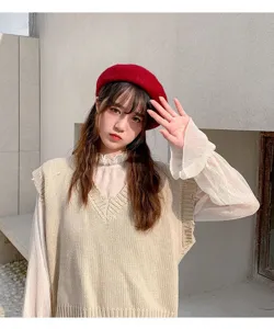 Details shot of the Korean style red wool beret women hat, stylish and warm autumn wear.