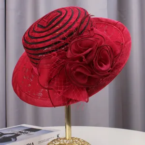 Red vintage lace floral fascinator hat detail, elegant cocktail party headwear view.