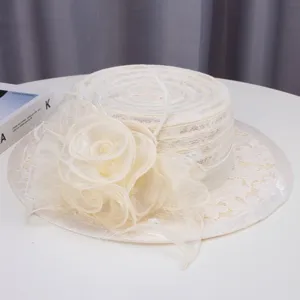 Vintage white lace flat top hat detail, elegant mesh flower decor for summer style.