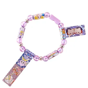 Children DIY sticker bracelet toy with purple beads and holographic cute charms for kids.