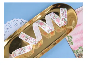 Decorative gold foil washi tape featuring delicate floral patterns for DIY scrapbooking journaling.