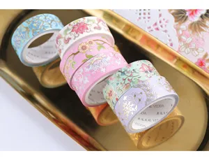 Detailed view of exquisite gold-foil floral washi tape rolls set for DIY journaling crafts.