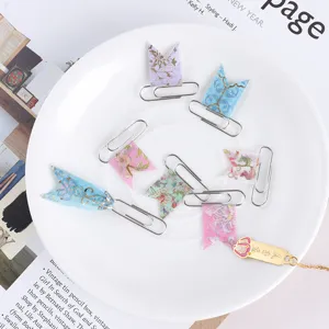 Decorative washi paper clips set with gold foil floral flags for journal planning DIY.