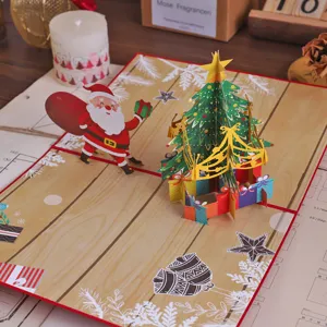 Detailed view of 3D pop-up Christmas tree greeting card with cute Santa design for holiday gifts.