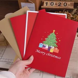 Detailed view of 3D pop-up Christmas tree greeting card with handmade paper craft design.