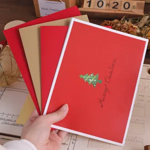 Detailed close-up of 3D pop-up Christmas tree greeting card with red and gold layered design.