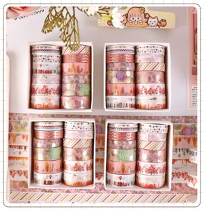 Boxed gold foil washi tape sets for journaling, scrapbooking, and decorative crafts.
