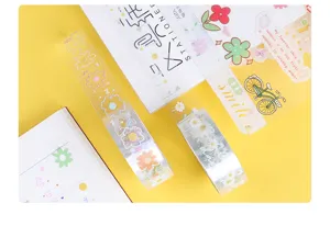 Detailed close-up view of clear PET decorative tape featuring cute summer daisy flower patterns.