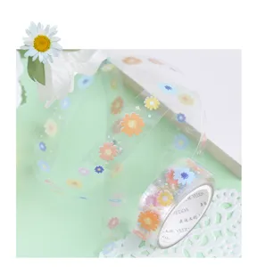 Detailed shot of transparent PET decorative tape featuring colorful summer daisy floral patterns.
