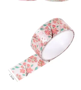 Pink cherry blossom washi tape with gold foil details, perfect for DIY scrapbooking journal crafts.