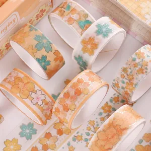 Beautiful gold foil sakura washi tape rolls for DIY journaling and scrapbooking crafts.