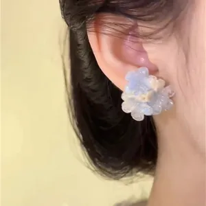 Close-up detail of the gradient blue flower earring, highlighting exquisite petal texture.