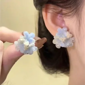Close-up detail shot of resort-style dopamine gradient blue flower earrings, sweet floral design.