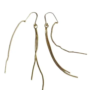 Close-up details of trendy long metal chain tassel earrings, showcasing exquisite craftsmanship.