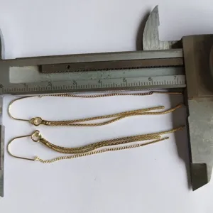Gold long chain tassel threader earrings detail shot showing product length and size design.