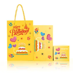 Yellow birthday gift bag and surprise box set detail showcasing cute cake and balloon prints.