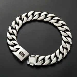 Close-up of thick stainless steel cuban link dog chain collar detail with sturdy snap buckle.