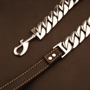 Detailed view of heavy duty stainless steel Cuban link dog leash with black leather and stitching.