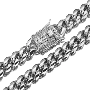 Detailed close-up of a gleaming silver stainless steel Cuban link chain with a paved clasp.
