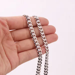 Detail shot of thick silver cuban link chain, showcasing the 6-side cut and stainless steel texture.