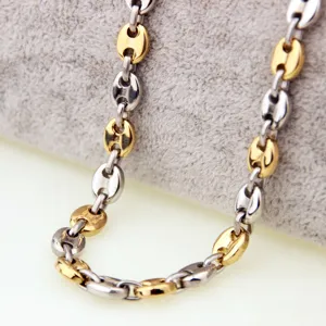 Stainless steel two-tone coffee bean chain detail, gold and silver link necklace design.