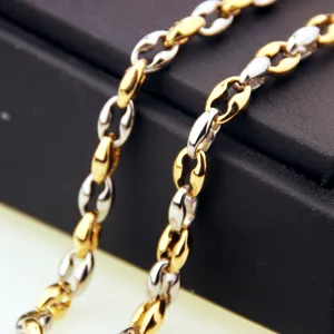 Detailed closeup of men's two-tone stainless steel coffee bean chain link jewelry.