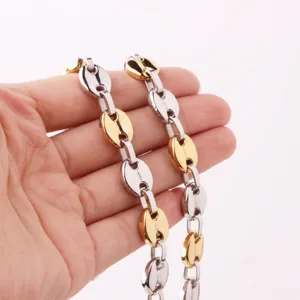 Close-up detail of the two-tone coffee bean chain necklace, showing the polished texture.