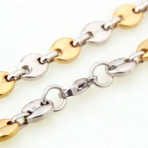 Stainless steel two-tone coffee bean chain link detail, polished gold and silver finish close up.