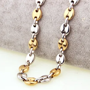 Detailed shot of two-tone coffee bean chain necklace, gold and silver stainless steel links.