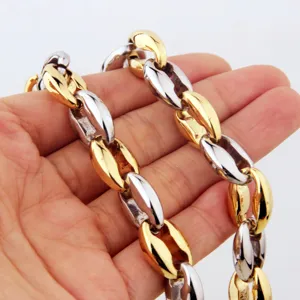 Close-up of a chunky two-tone coffee bean chain necklace, showing metal links and texture.