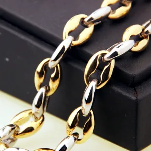Close-up detail of mens two-tone gold and silver stainless steel coffee bean chain necklace.