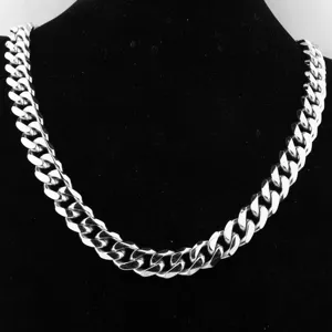 Close-up detail of a thick silver cuban link chain necklace for men, polished finish.