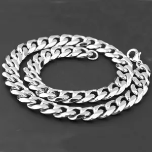 Detailed shot of silver stainless steel cuban link chain, durable metal texture for men.