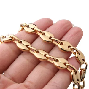 Close-up detail of gold stainless steel coffee bean chain necklace showing polished metal links.