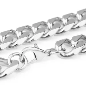 Detail shot of silver stainless steel cuban link chain, showing polished links and clasp.