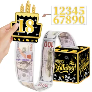 Set de caja de dinero de cumpleaños con adorno de torta negro y dorado y rollo sorpresa.