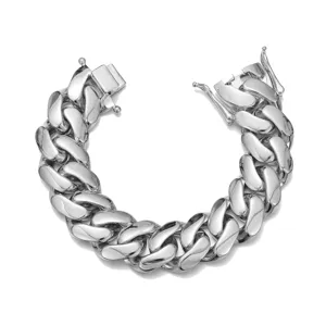 Close-up detail of a heavy silver stainless steel Cuban link bracelet with polished finish.