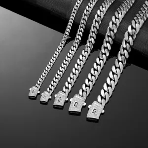 Detail shot of men's stainless steel Cuban link chains, showing high polished finish and paved clasps.