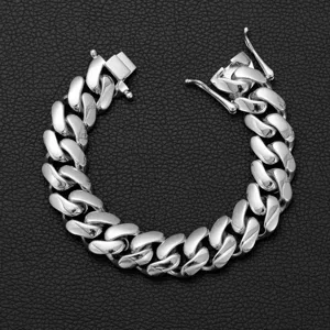 Close-up detail of stainless steel Cuban link bracelet, high polished silver finish for men.