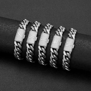 Detailed view of stainless steel cuban link chains with rhinestone letter clasps.