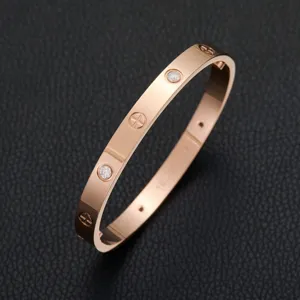 Elegant rose gold plated stainless steel bracelet with sparkling crystal stones and screw motifs.