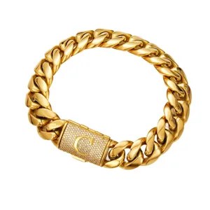 Detail view of gold cuban chain necklace featuring paved crystal clasp with letter C design.
