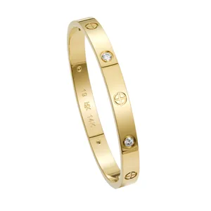 Detailed shot of a stylish 14K gold plated stainless steel moissanite bangle bracelet.