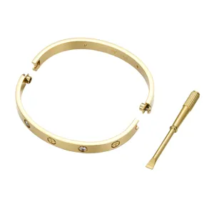 Close-up view of the 14K gold plated stainless steel screw motif bangle bracelet detail.
