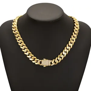 Detailed view of gold Cuban link chain necklace featuring sparkling rhinestone clasp lock.