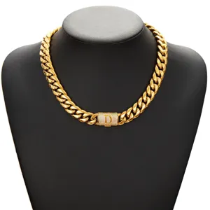 Detailed view of the gold Cuban link chain necklace featuring a pavé letter D lock clasp.