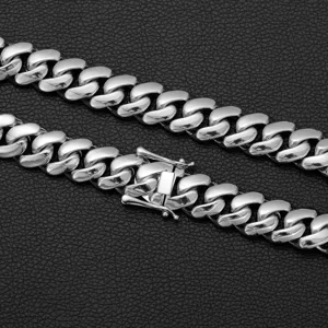 Close-up detail shot of a heavy silver stainless steel Cuban link chain necklace with secure box clasp.