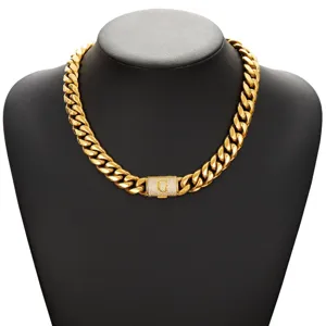 Close-up detail of the gold cuban link hip hop necklace featuring a paved letter clasp.